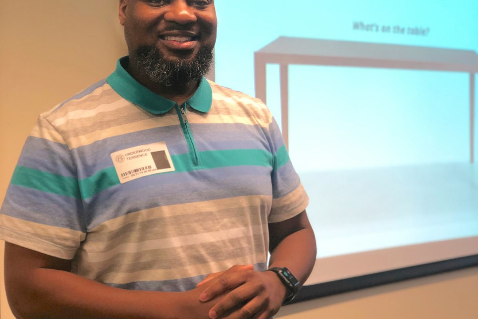 A facilitator smiling during a teacher training workshop